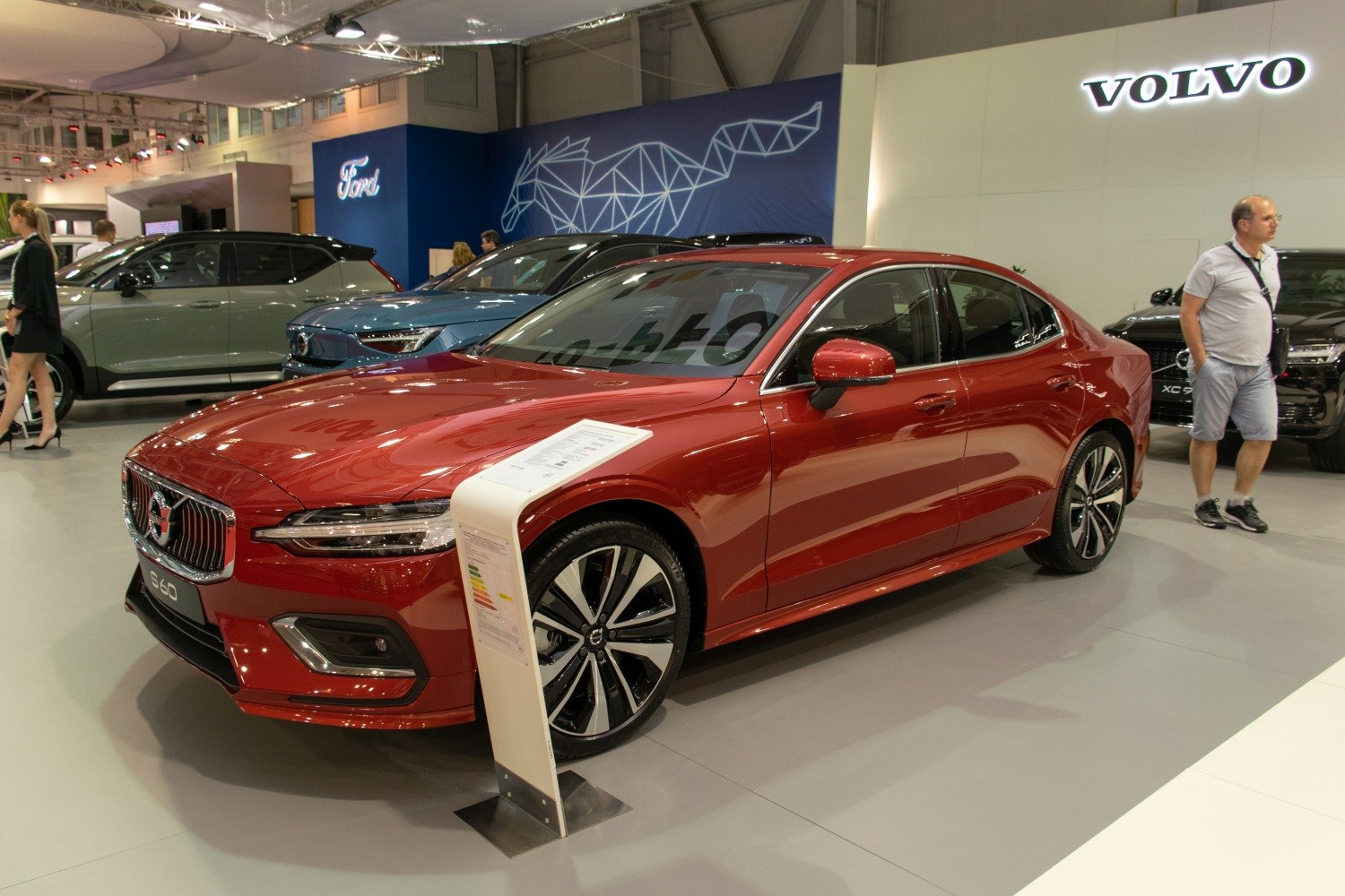 Front and side profile of a red modern sedan with alloy wheels.