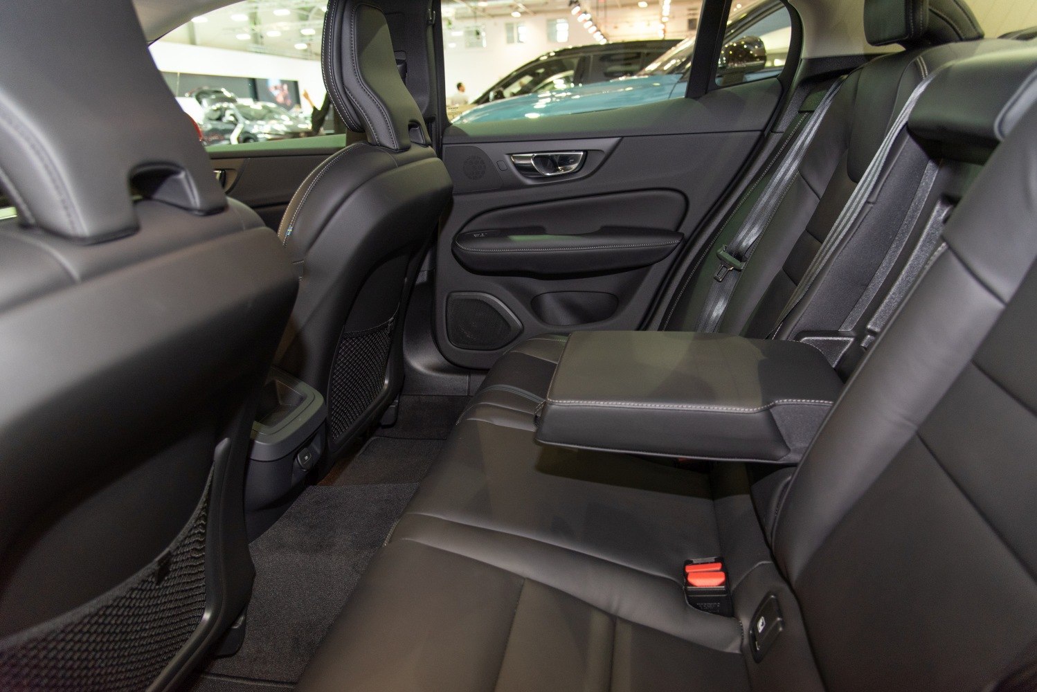 Luxury rear seat interior with black leather and fold-down armrest