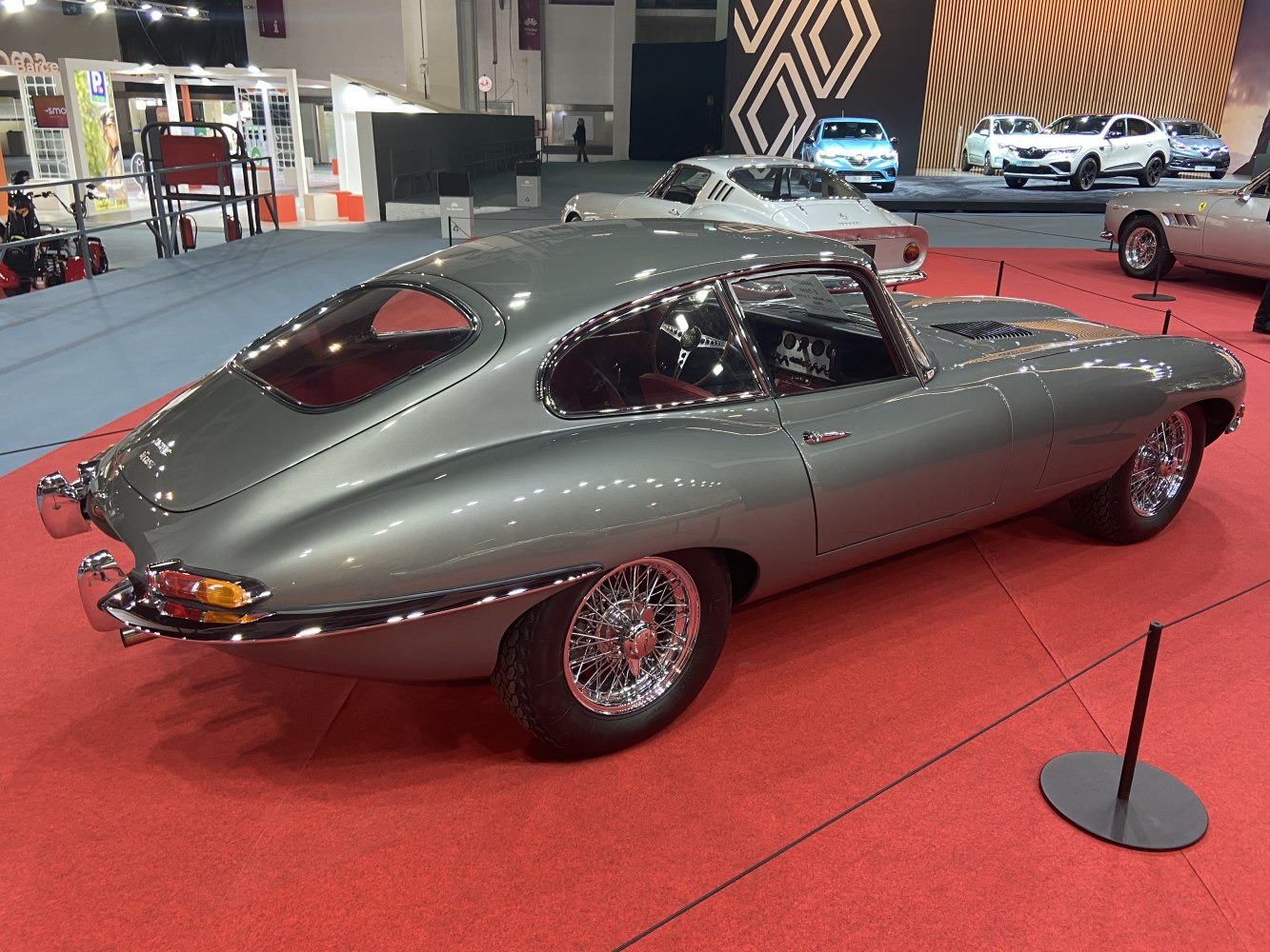 Grey coupe with elegant curves and wire-spoke wheels