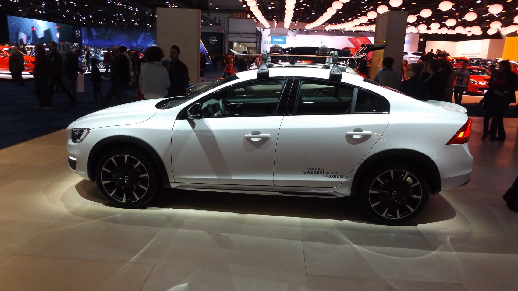White sedan with roof rack and black alloy wheels