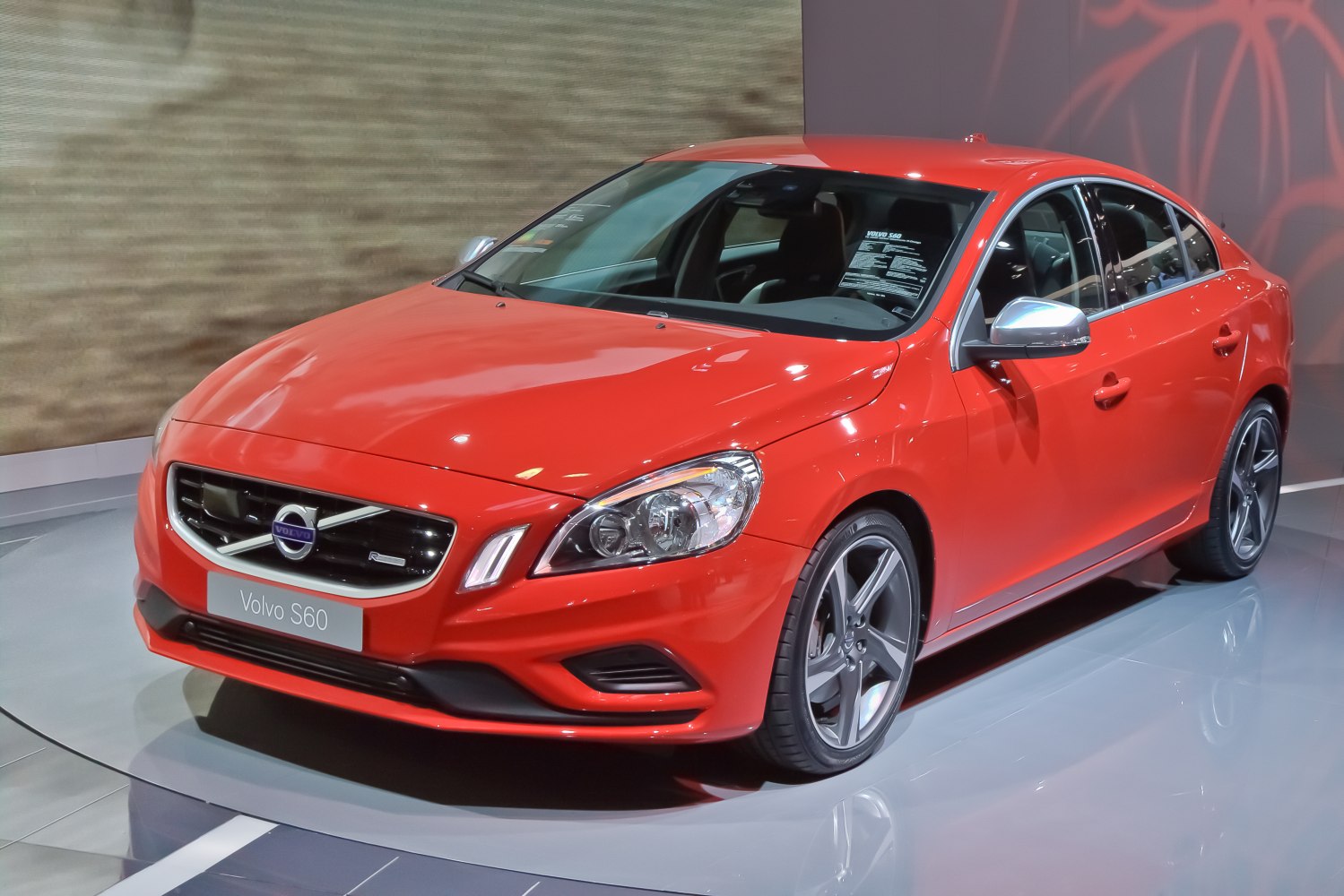 Red sedan with stylish alloy wheels and distinct front grille