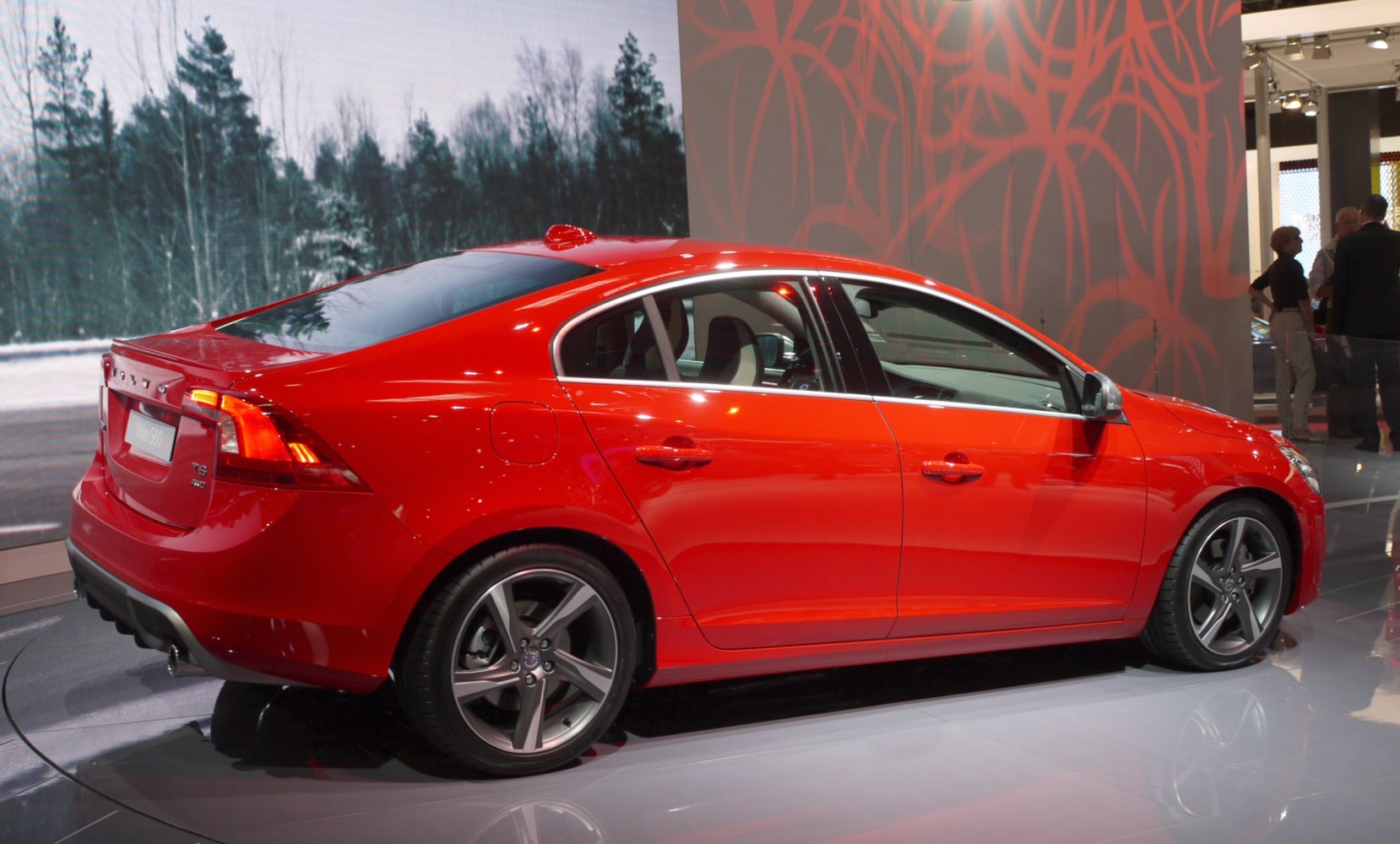 Red sports sedan with alloy wheels and sloping roofline