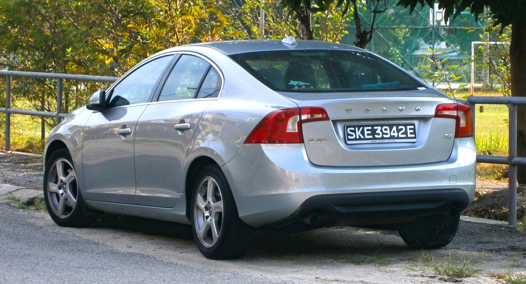 Silver sedan rear with prominent taillights and alloy wheels
