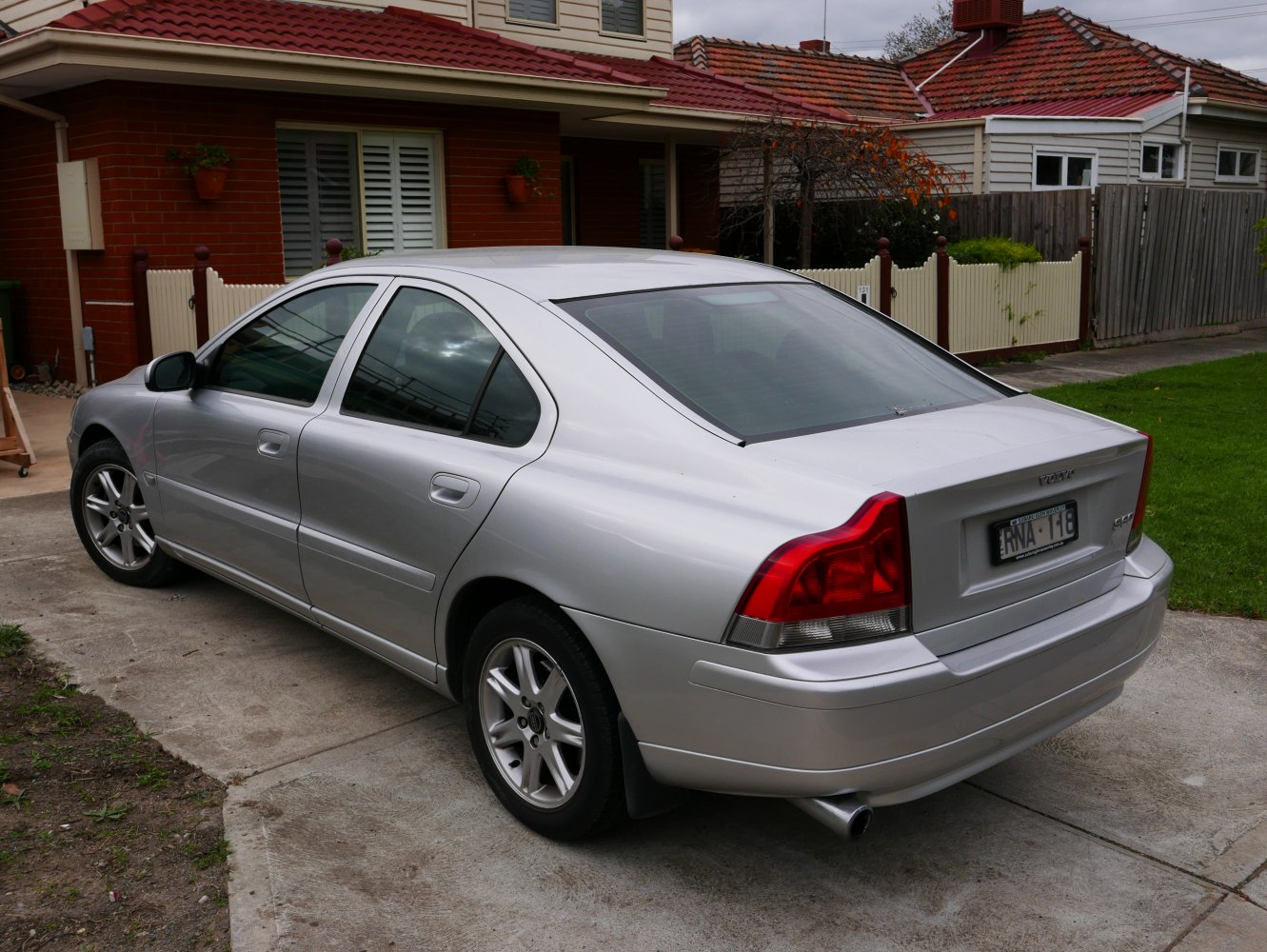 Silver sedan rear and side view with alloy wheels and distinctive taillights.