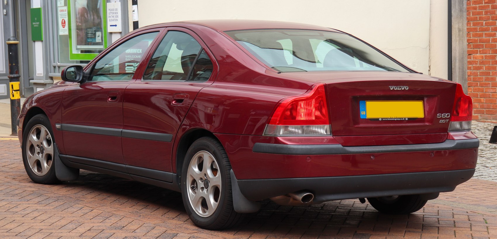 Rear and side view of sedan with classic taillights and smooth body lines