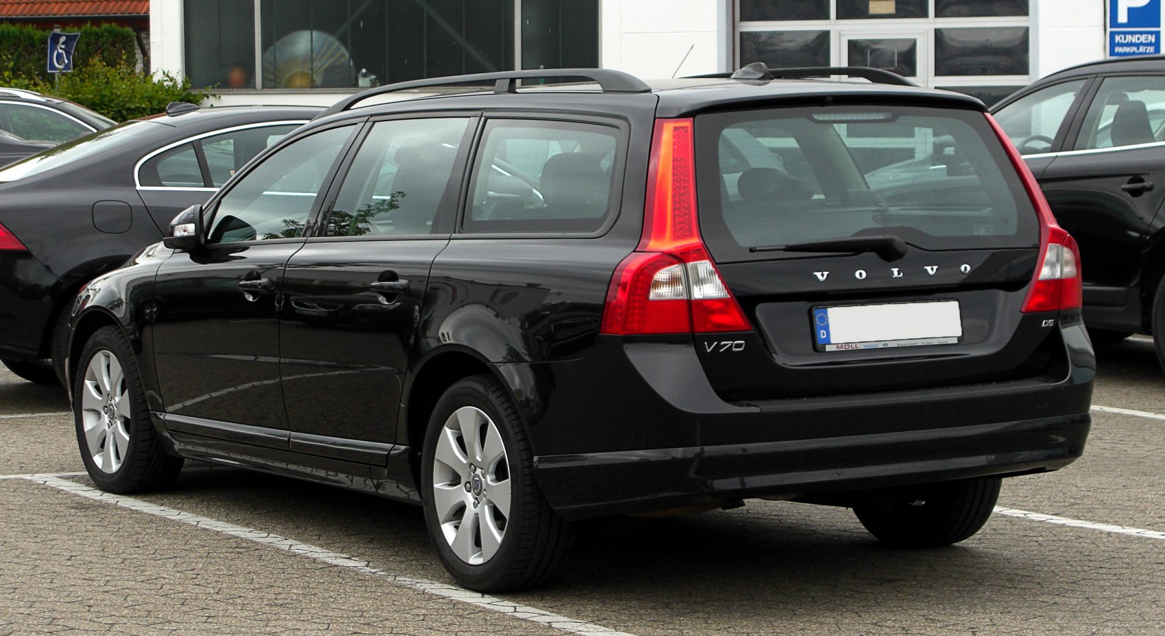 Black station wagon with vertical rear lights and roof rails