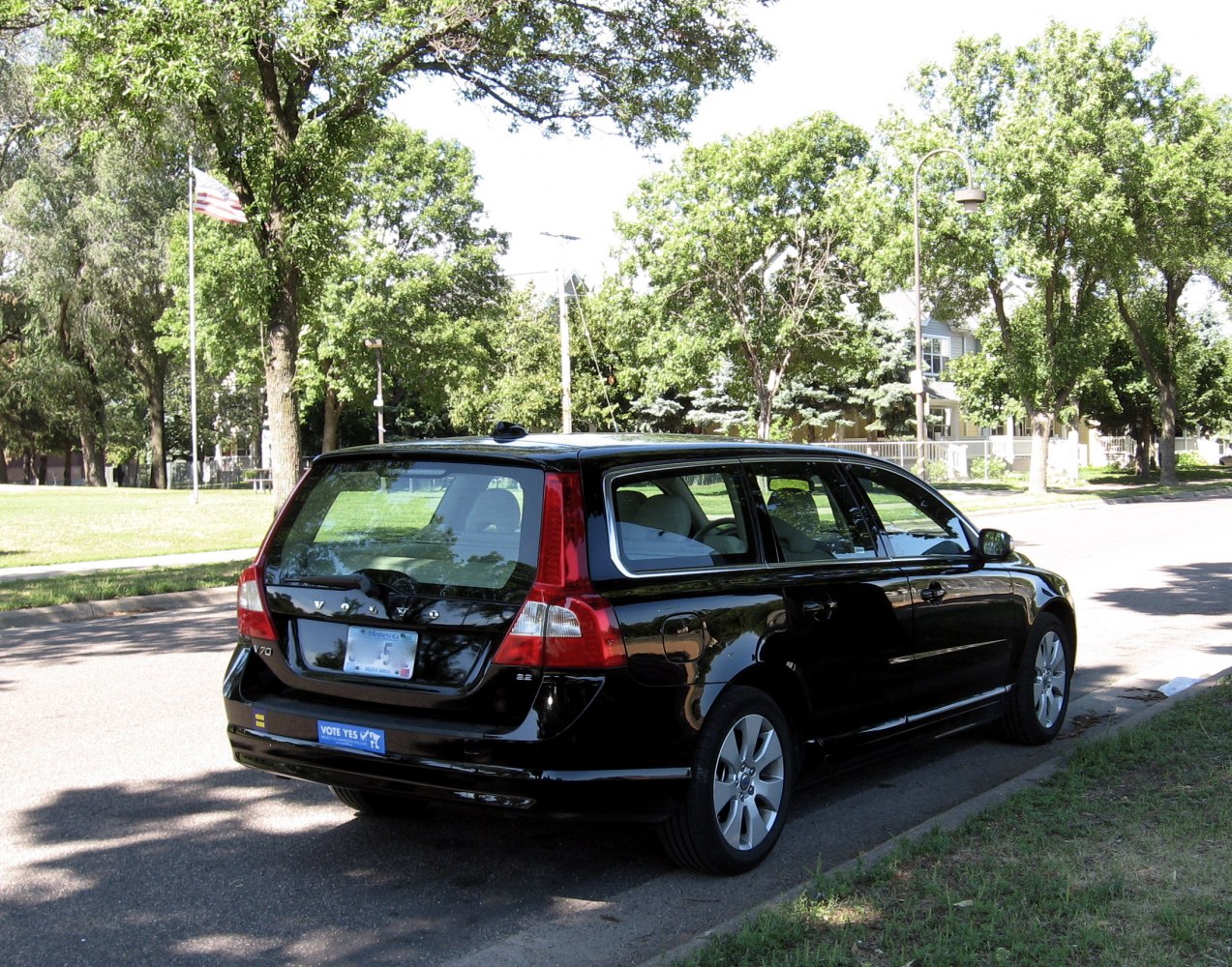 Black station wagon rear view with distinct tail lights and large rear window