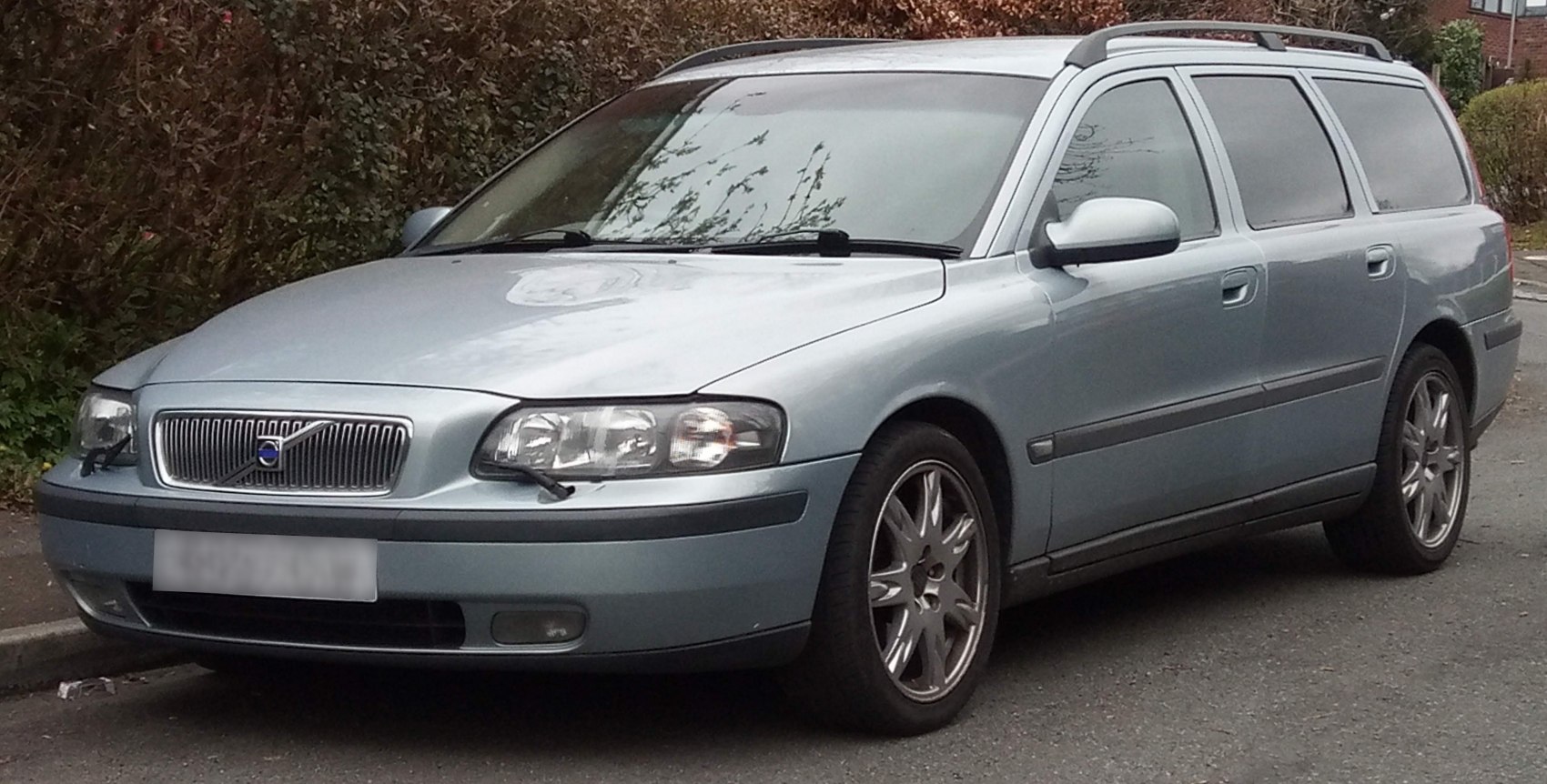Silver estate car with roof rails, alloy wheels, and headlight wipers.