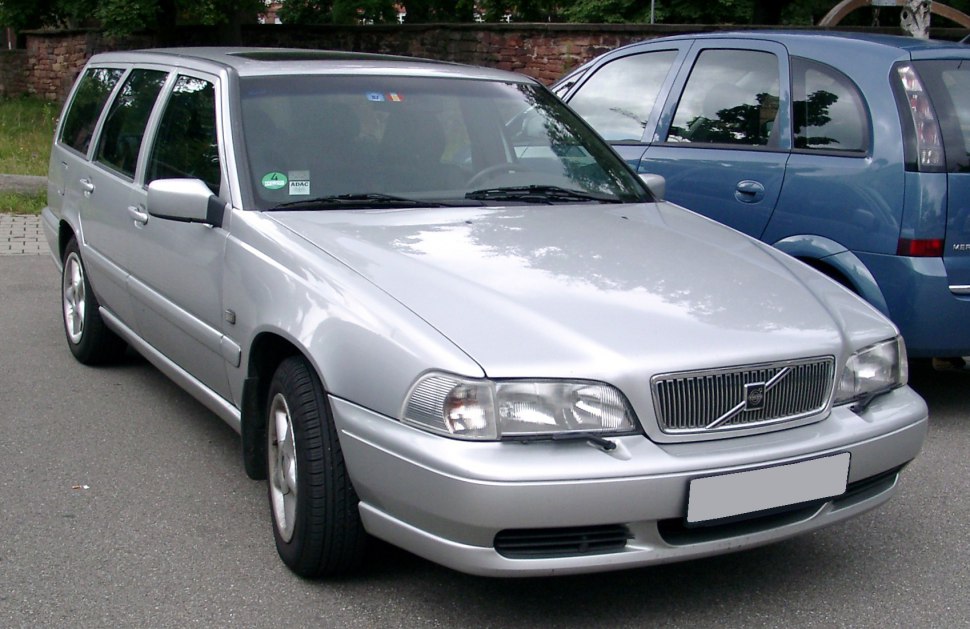 Silver station wagon with front grille and headlights in view