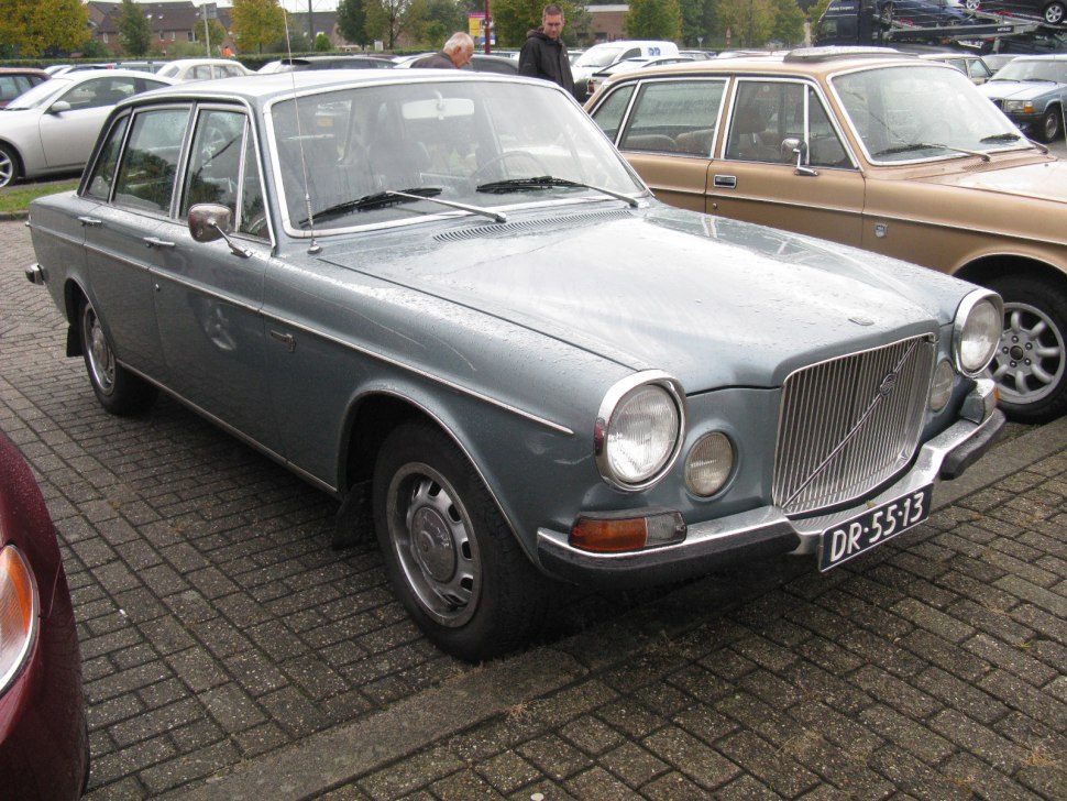 Front view with round headlights and chrome grille on classic sedan