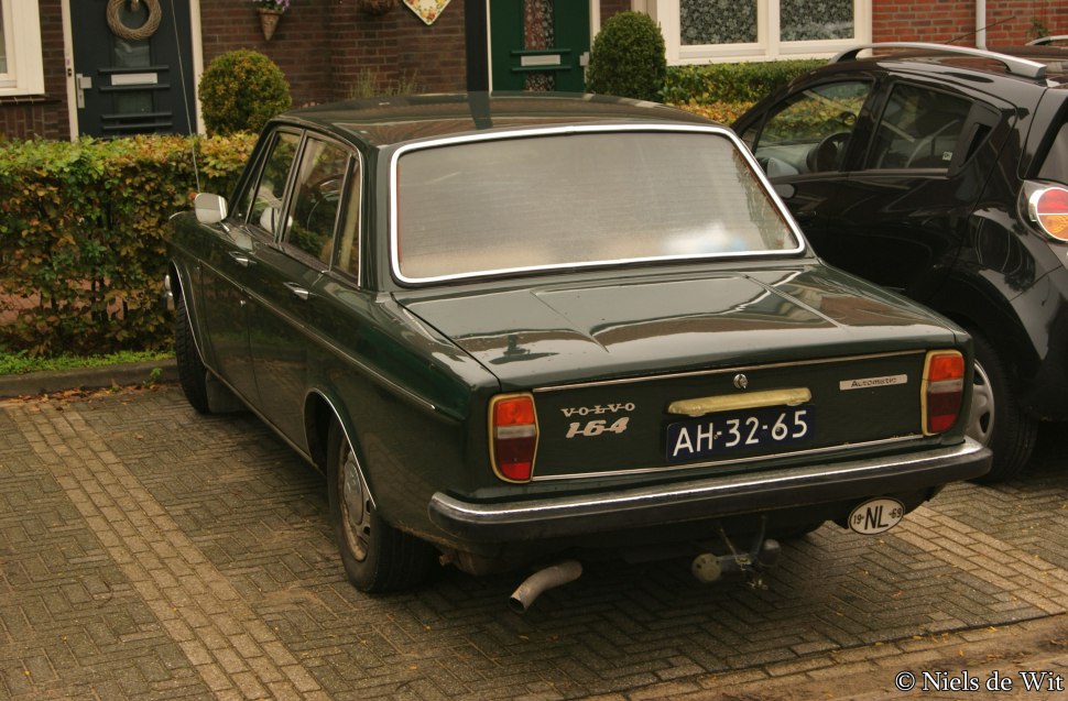 Rear view of a classic sedan with rectangular taillights and chrome bumper.
