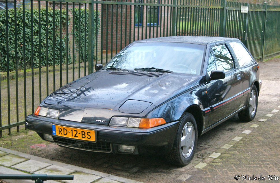 Retro hatchback with angular front and pop-up headlights.