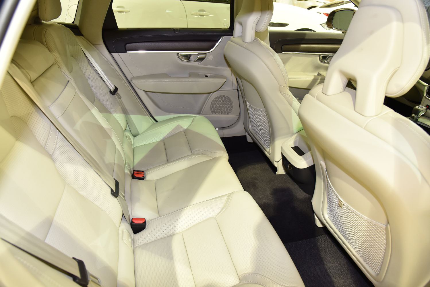 Beige leather rear seating with seat belts and door panel details