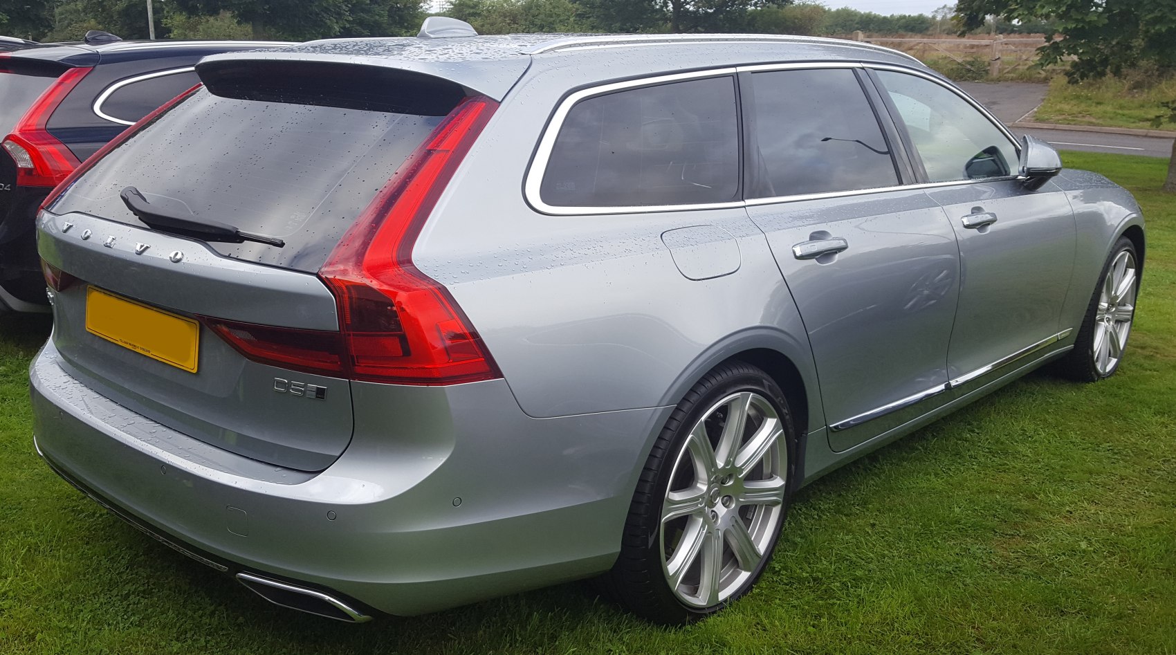 Rear and side view of silver station wagon with modern taillights and alloy wheels.