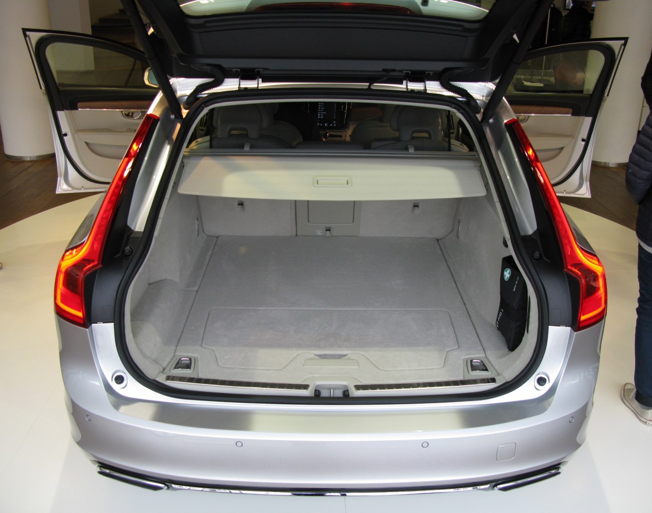 Open rear trunk cargo space with protective cover and light interior
