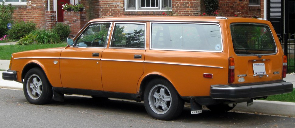 Vintage orange station wagon with classic boxy design and black bumper.