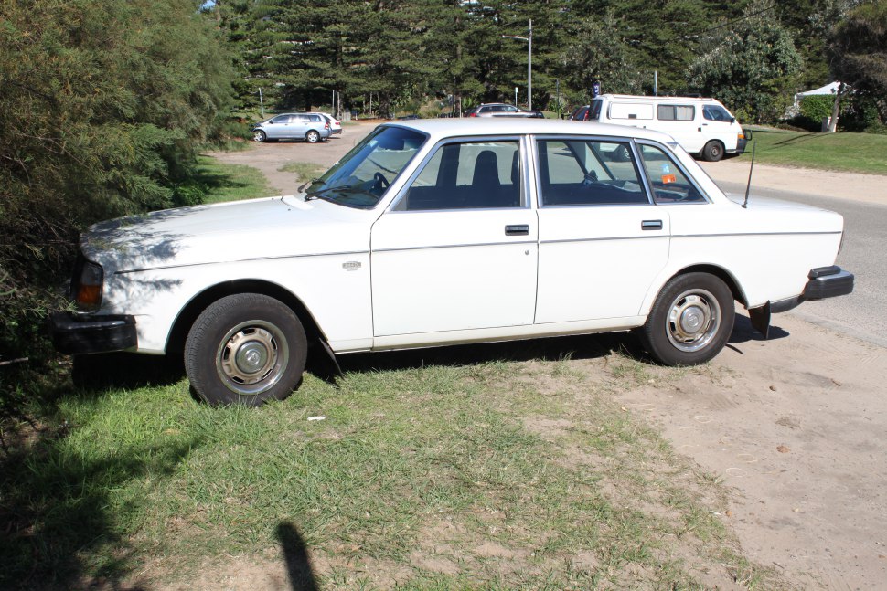 Side profile of classic boxy sedan with prominent four-door layout and steel wheels