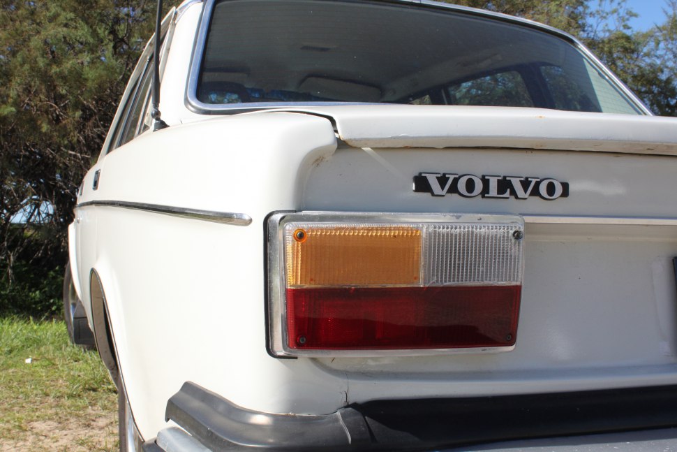 Close-up of rear left tail light and Volvo badge on vintage car
