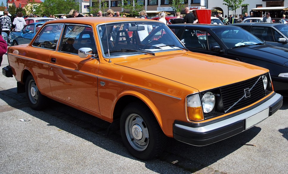 Orange vintage 1970s coupe with angular headlights and steel wheels