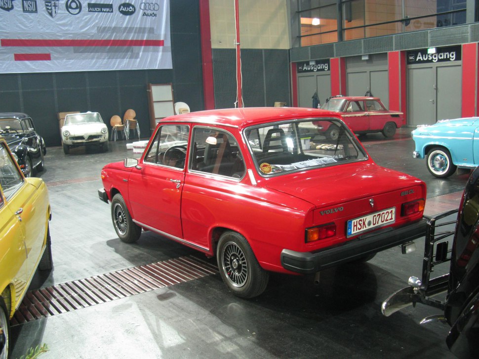 Red classic compact sedan with distinctive rear design and alloy wheels
