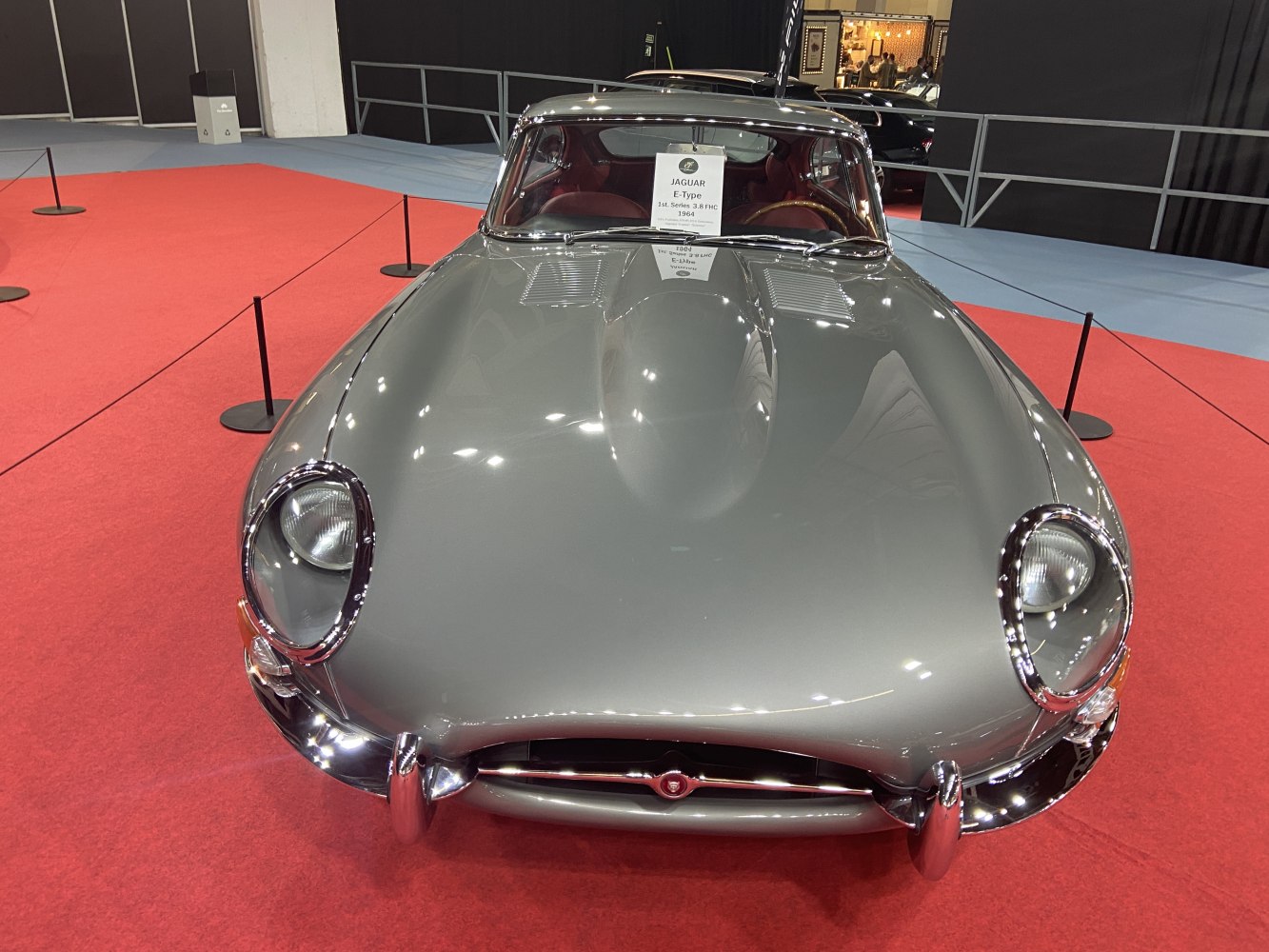 Front view with round headlights and aerodynamic bonnet of a classic vintage car.