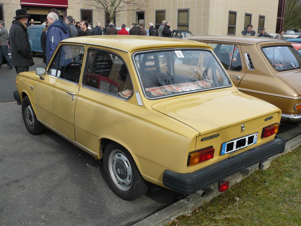 Vintage compact sedan with rectangular tail lights and chrome trim