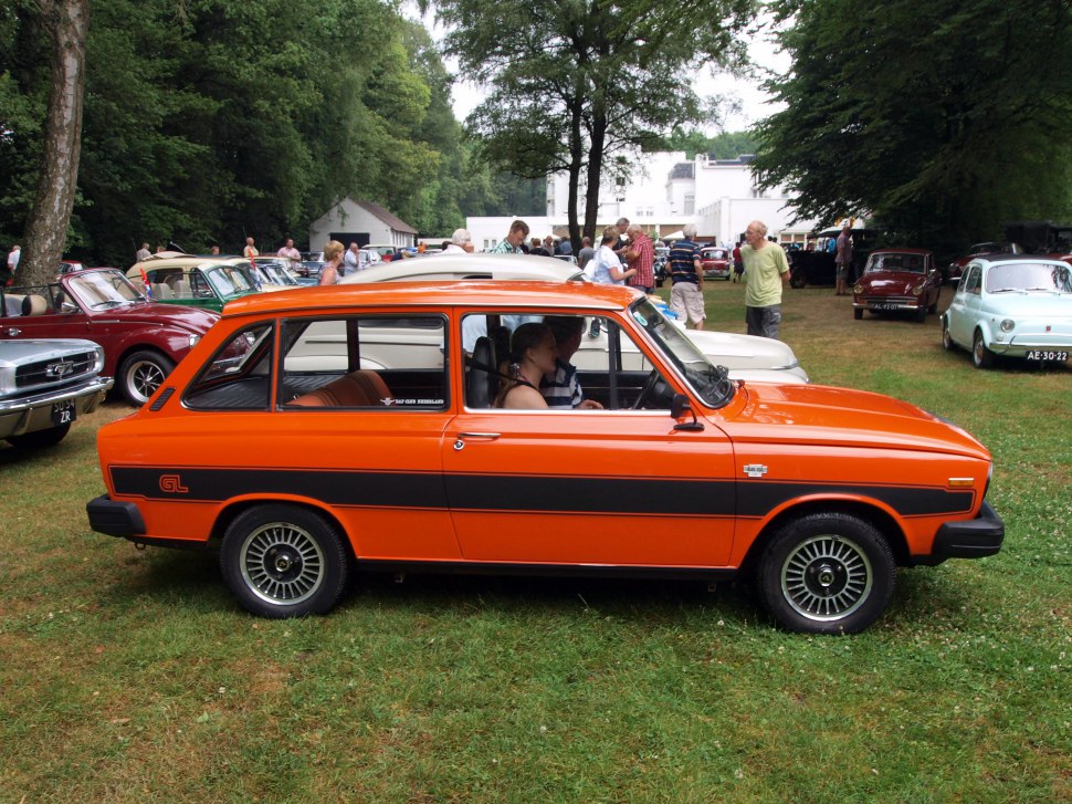 Orange station wagon with GL side stripe and vintage wheels
