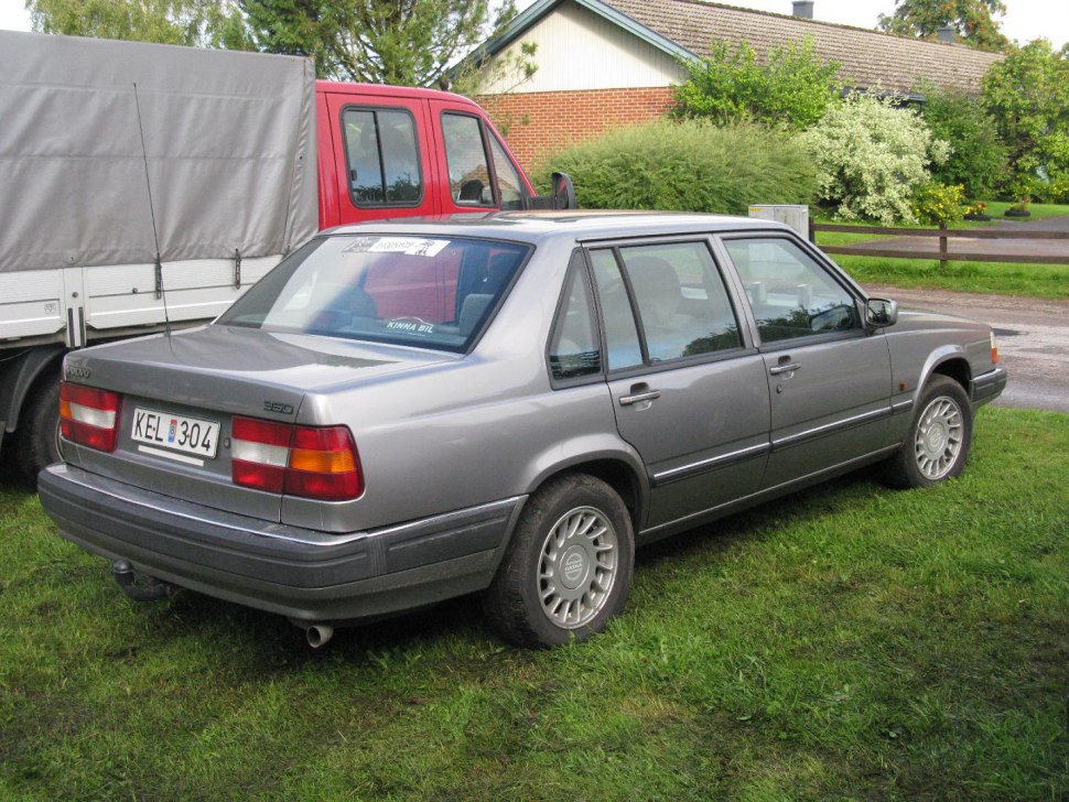 Rear-side silver grey 1991 sedan with distinctive boxy design and alloy wheels