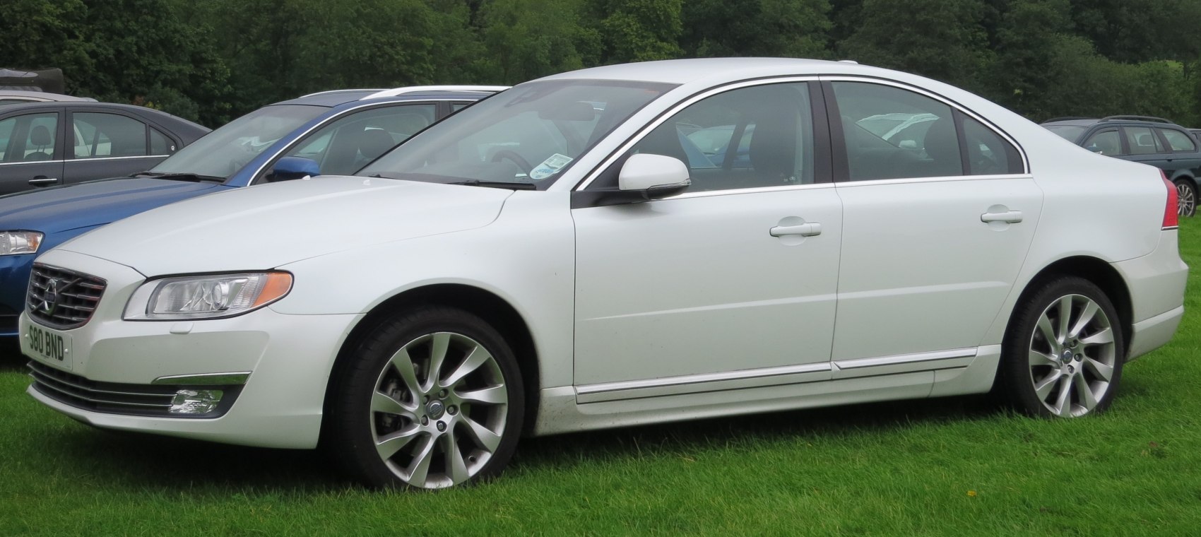 Sleek white luxury sedan side profile with alloy wheels