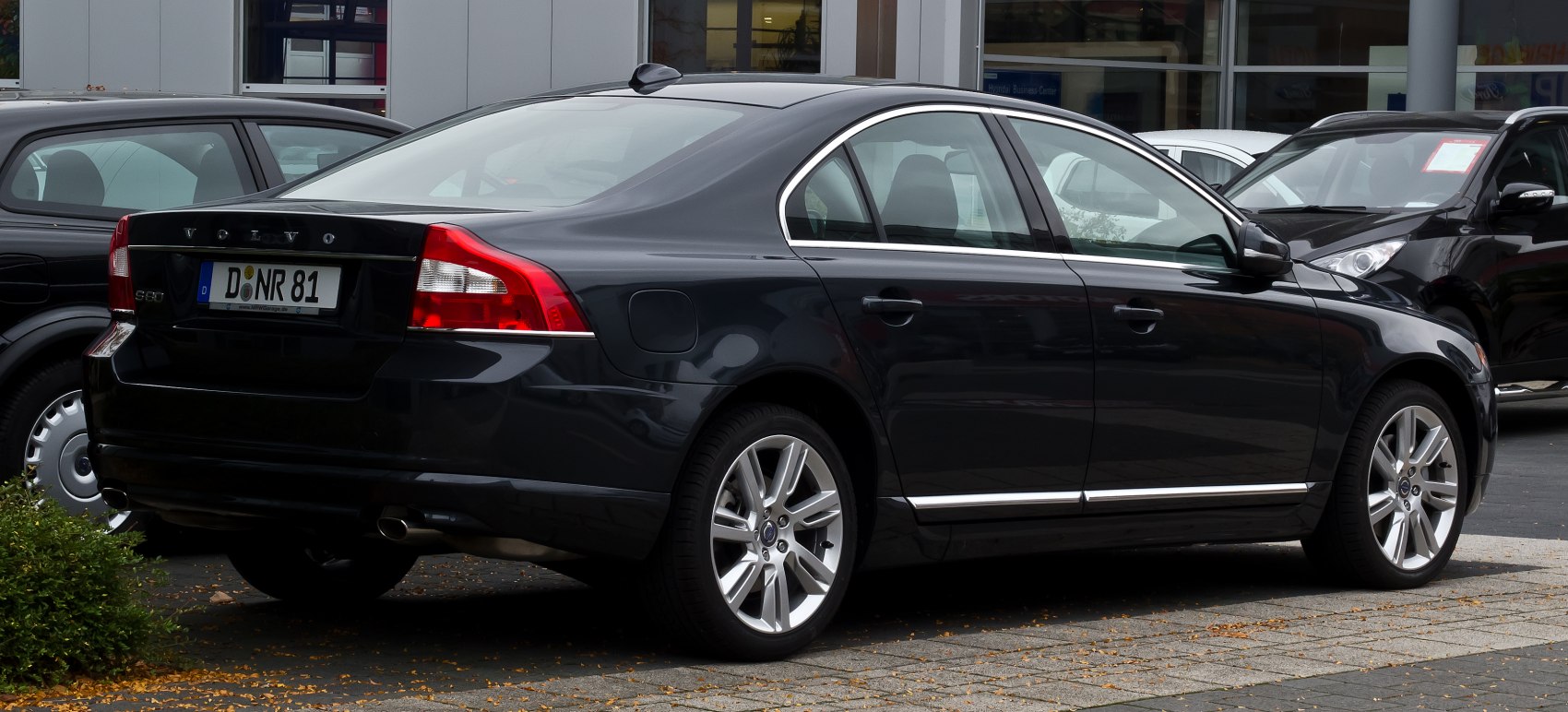Rear and side view of a sedan with distinct tail lights and alloy wheels