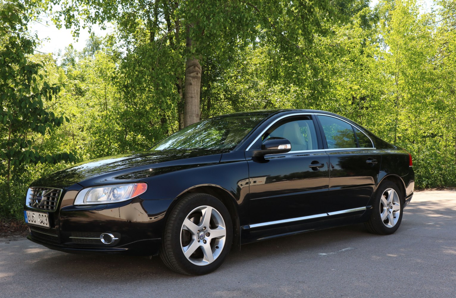 Sleek black four-door sedan with alloy wheels and chrome grille.