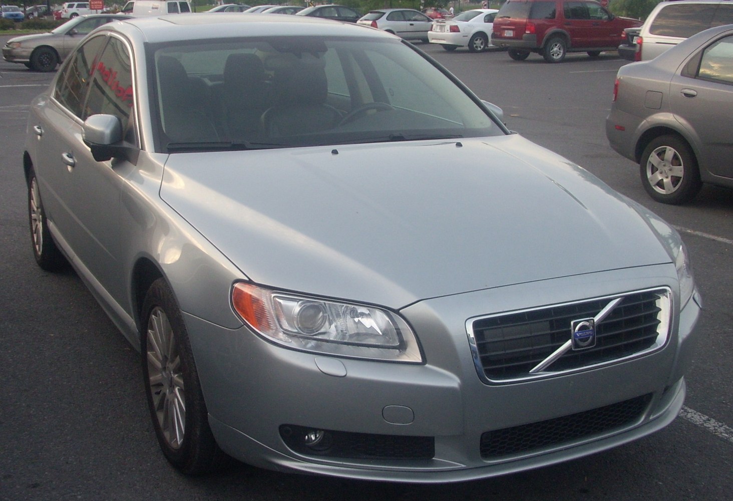 Front view of silver sedan with sleek headlights and chrome grille