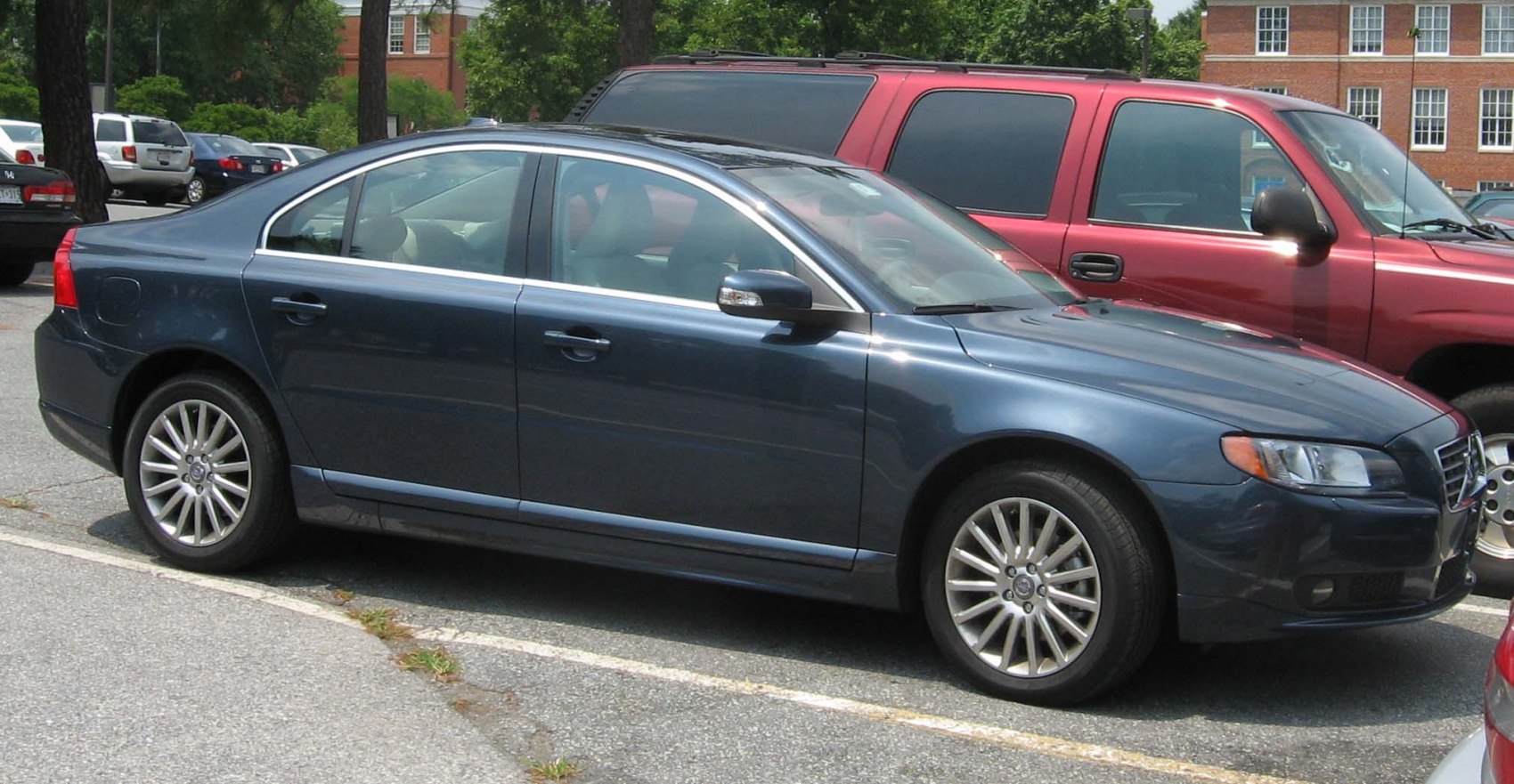 Side profile of a blue sedan with alloy wheels