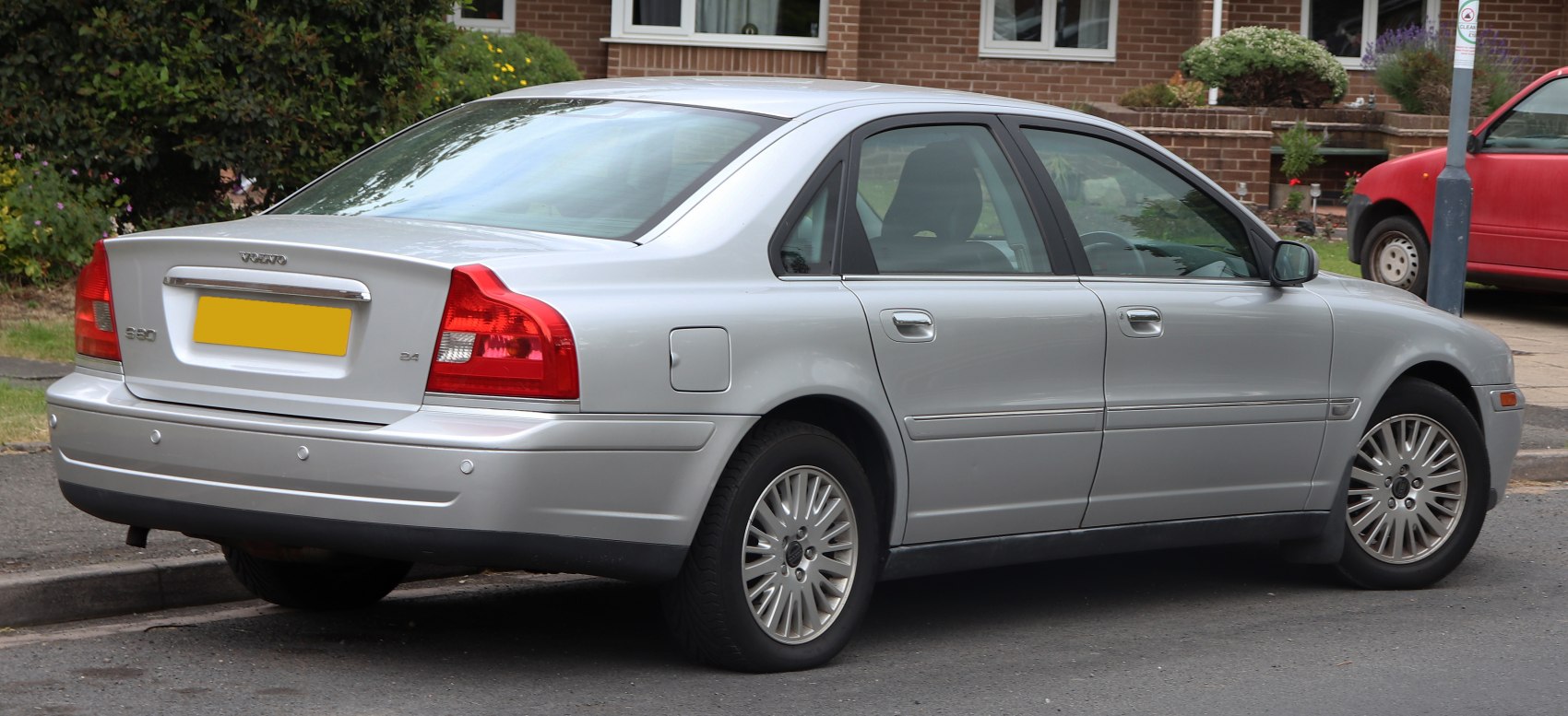 Silver sedan with distinct rear taillights and alloy wheels, side and rear view.