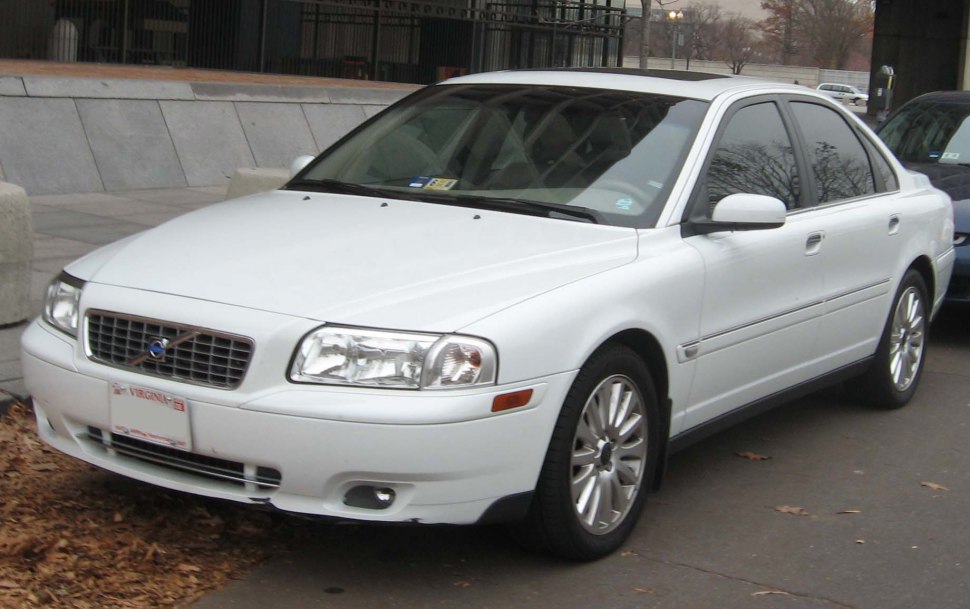 Front and side view of a white Volvo S80 sedan with hallmark grille and alloy wheels.