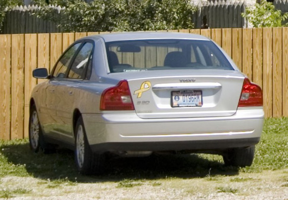 Silver sedan rear with distinct tail lights and trunk emblem