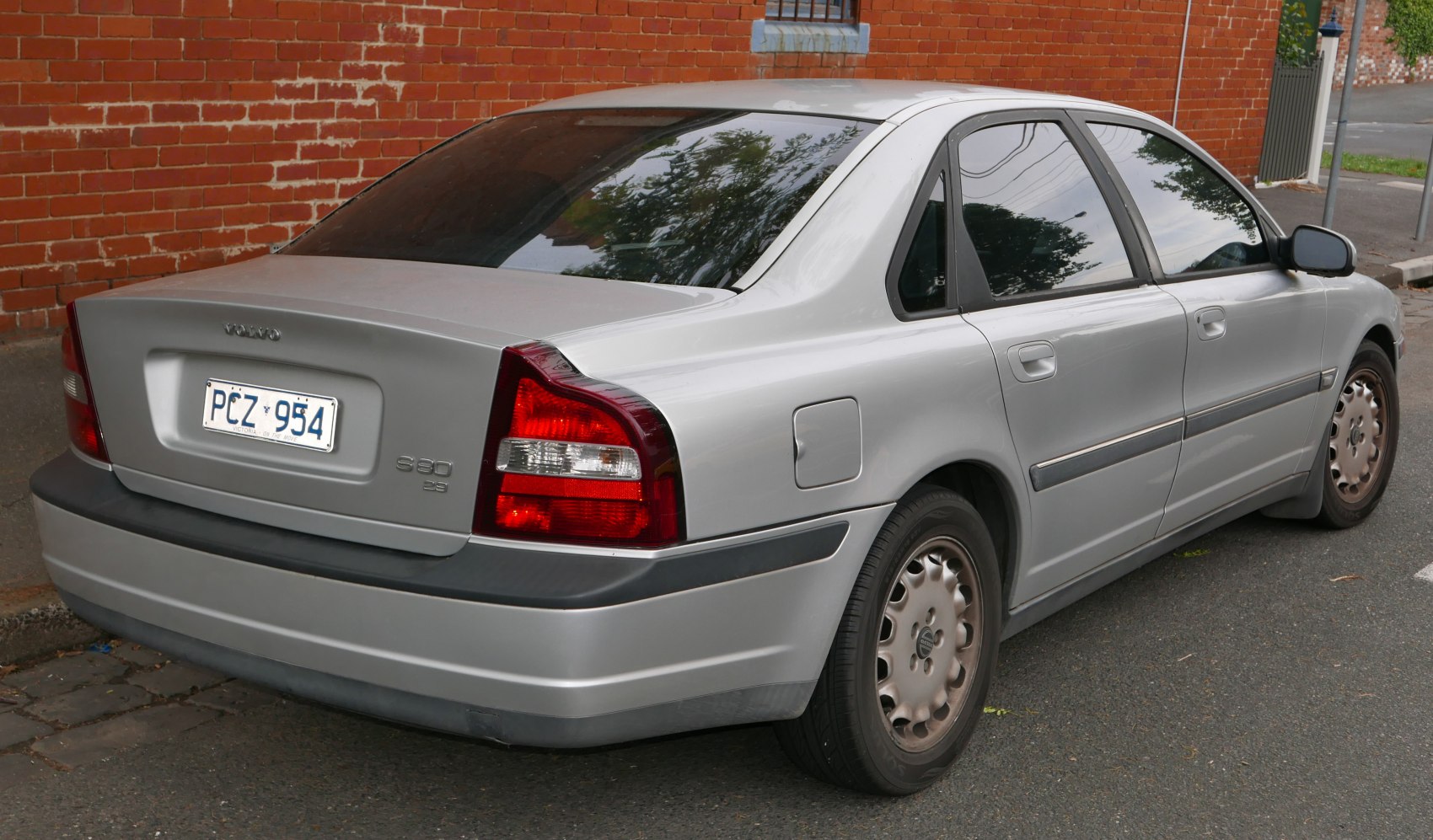 Rear and side view of silver sedan with distinct tail lights and alloy wheels