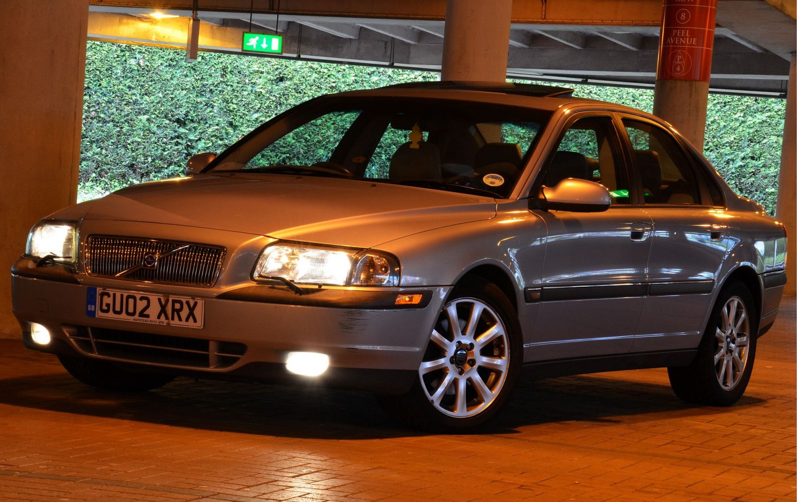 Front-side view with headlights on and alloy wheels