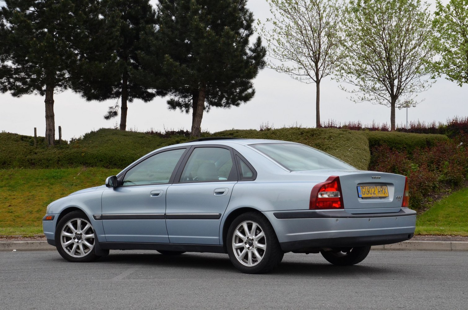 Rear side view of classic sedan with distinct taillights and sleek body lines