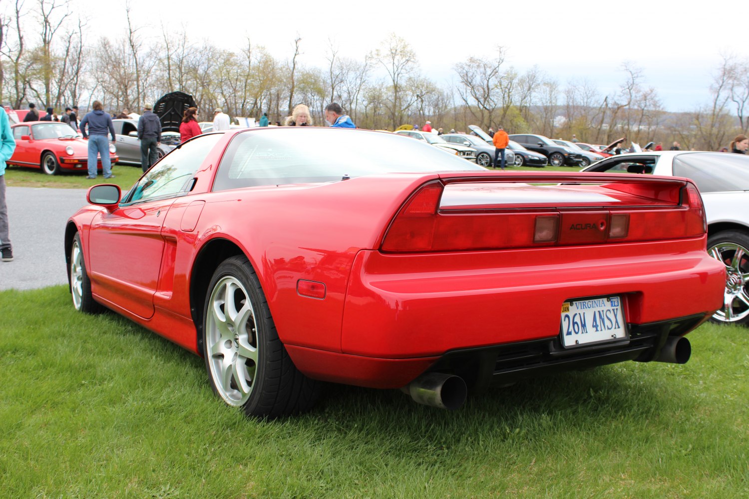 Red sports car rear view with iconic taillights and dual exhaust.