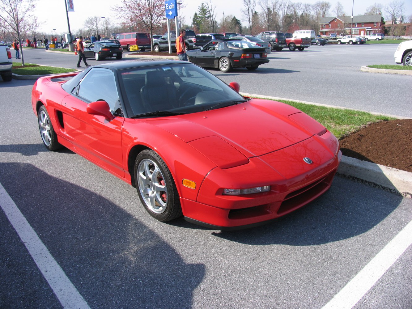 Red sports coupe with pop-up headlights and sleek aerodynamic design