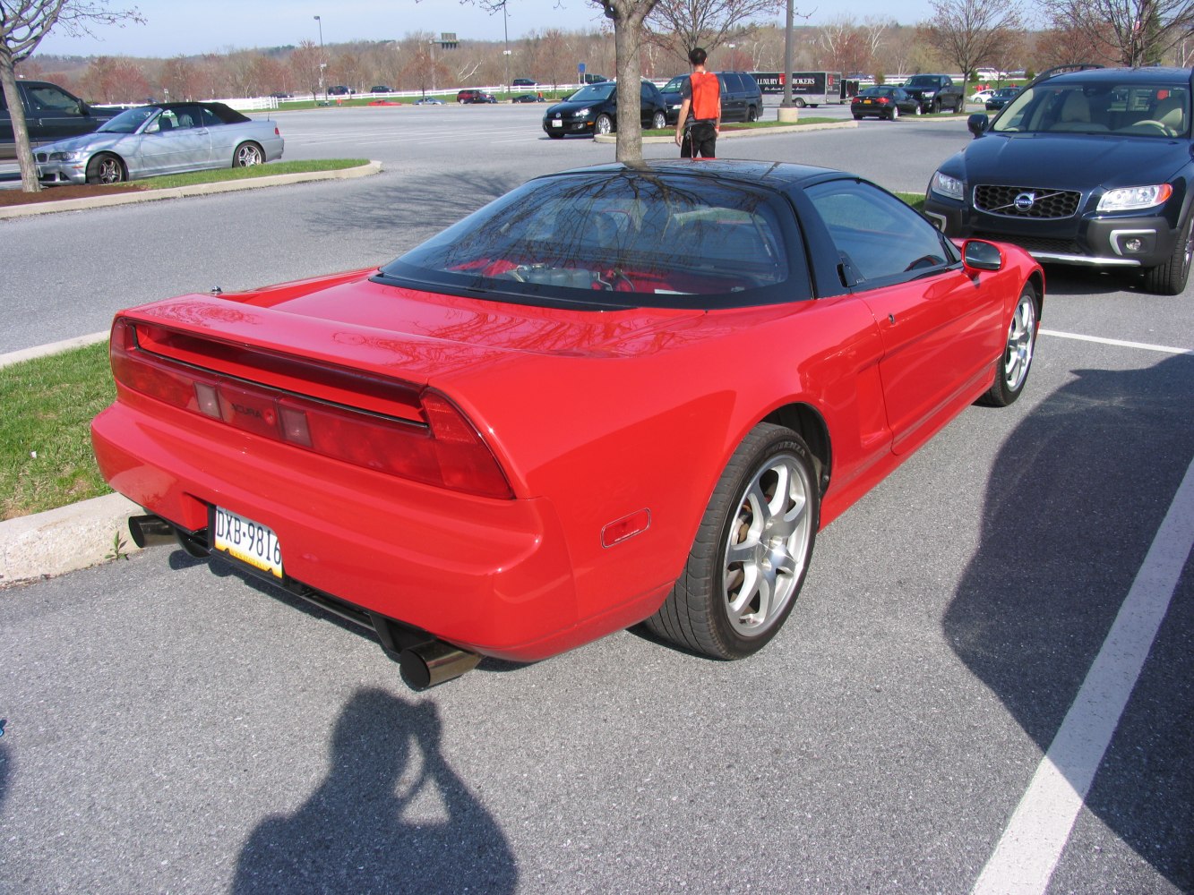 Red sports coupe rear view with distinctive taillights and sleek roofline.