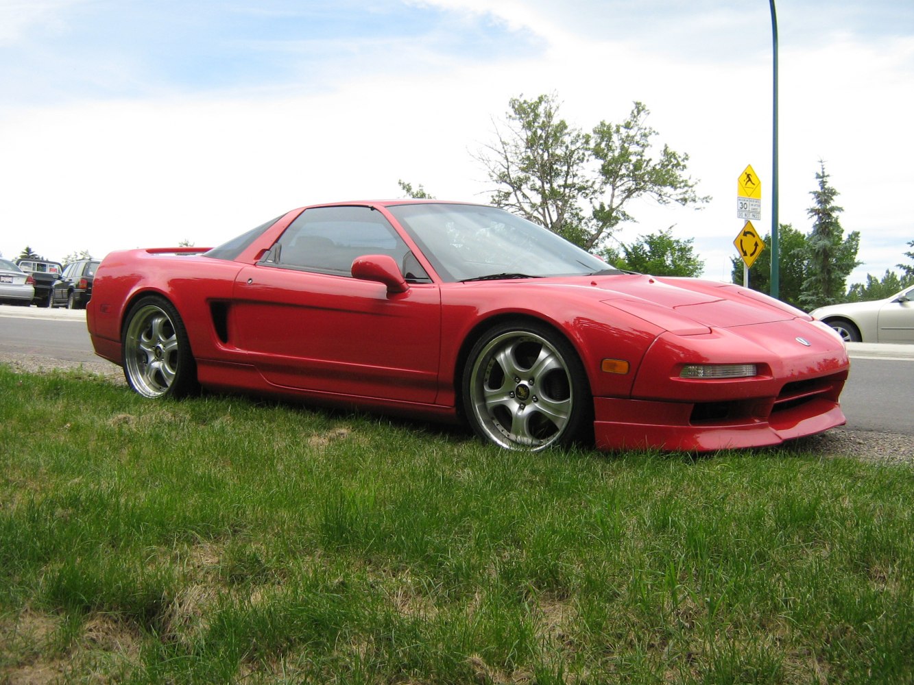 Red sports coupe with aerodynamic body and alloy wheels
