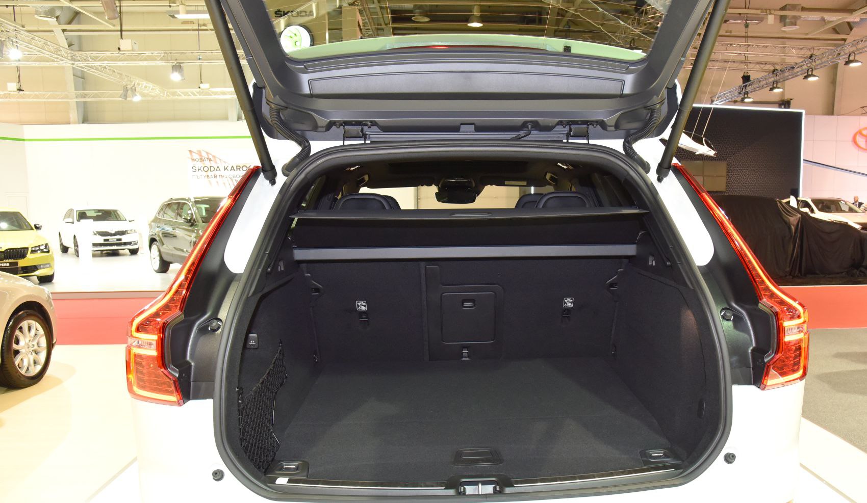 Spacious rear cargo area with open trunk and storage features