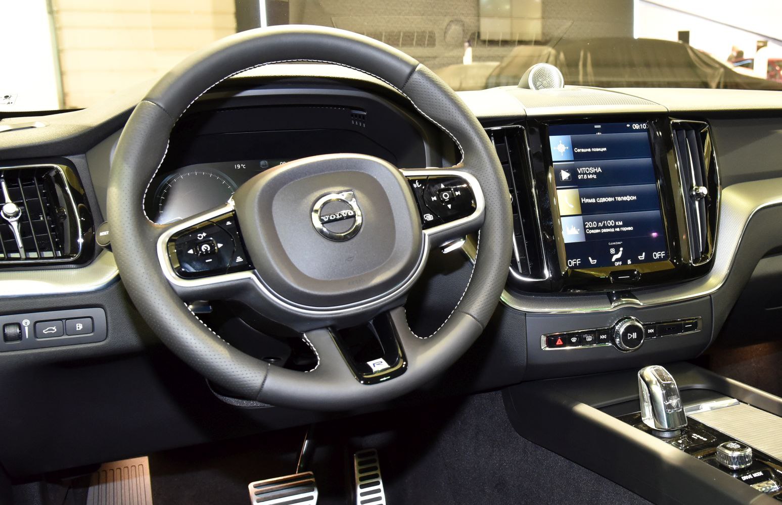 Steering wheel with controls and central touchscreen infotainment system