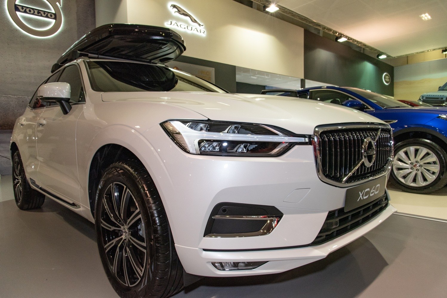 Front view of white SUV with LED headlights and roof box