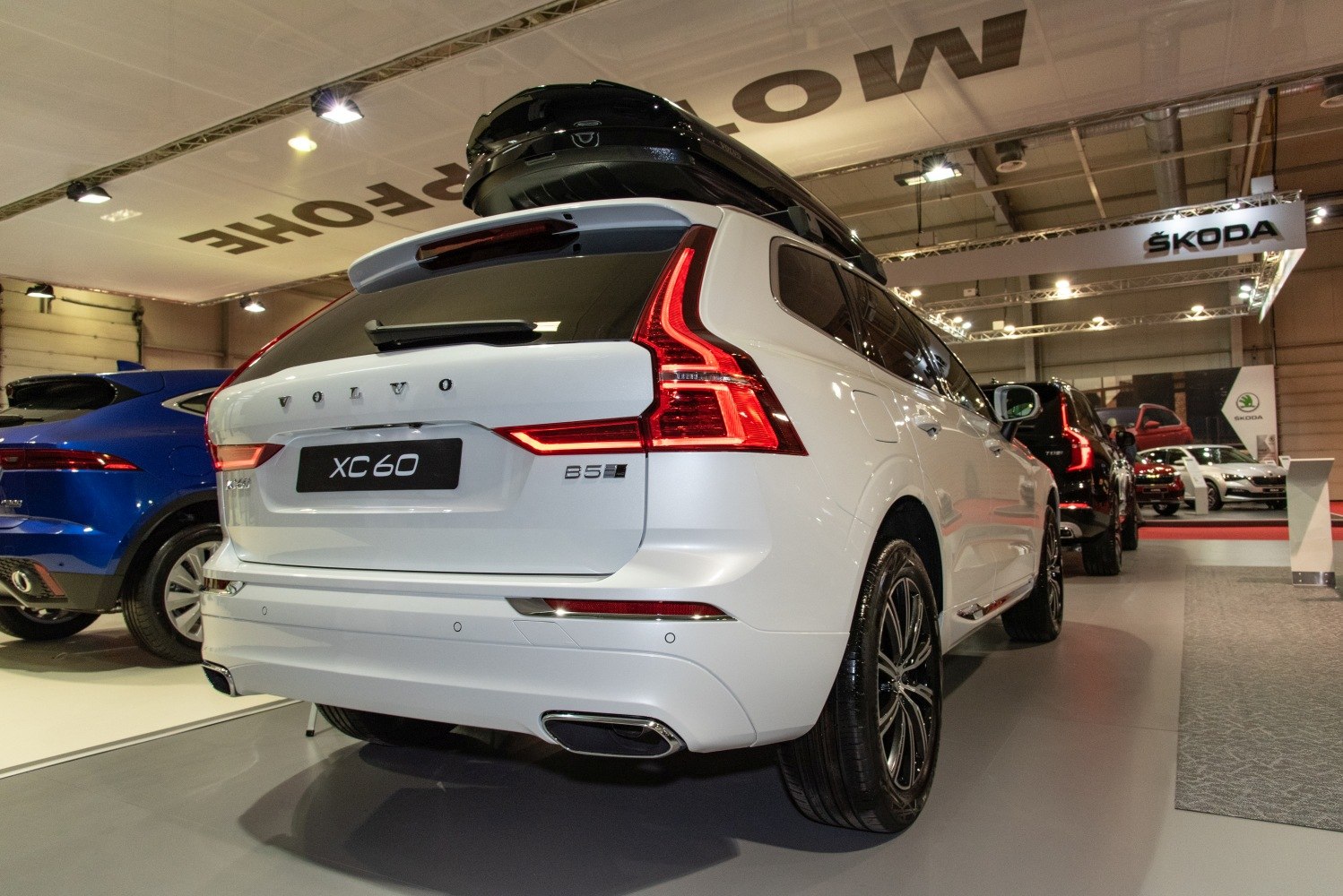 Rear view of SUV with roof box and prominent taillights