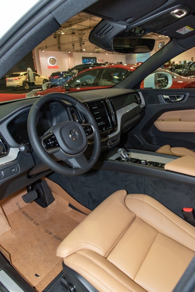 Tan leather seats and modern dashboard with steering wheel controls
