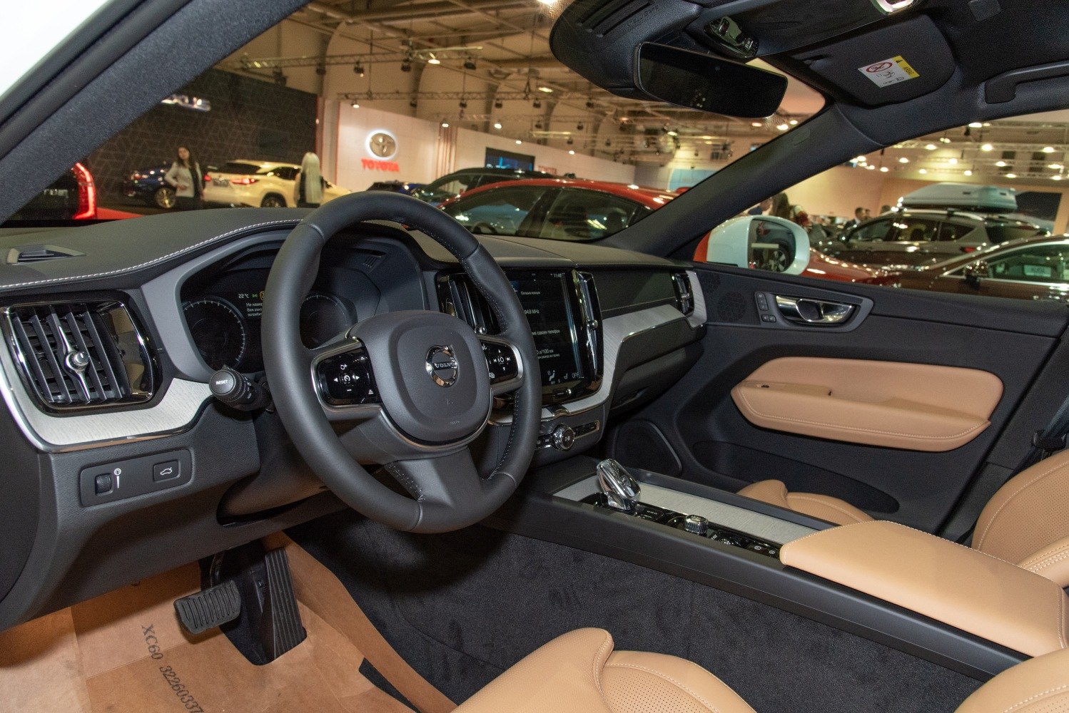 Interior dashboard and beige leather seats with touchscreen controls