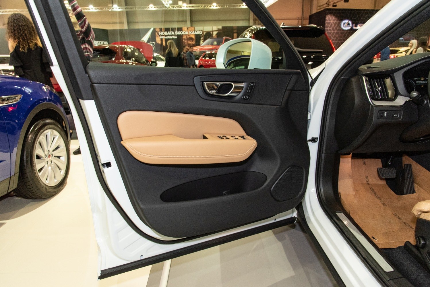 Front door interior panel with beige armrest and control buttons